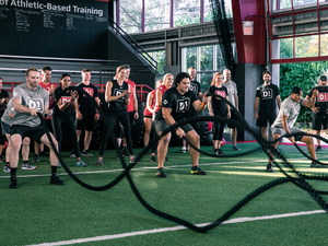 Group Sports Training program in Rogers doing battle rope exercises